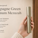Hand holding a modern waterproof Champagne Green Aluminum Mezuzah against a neutral background.