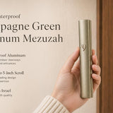 Hand holding a modern waterproof Champagne Green Aluminum Mezuzah against a neutral background.