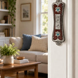 Pearlescent Kotel Heart pewter mezuzah with crystal blue accents mounted on a residential doorpost