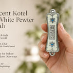 Hand holding Pearlescent Kotel Heart white pewter mezuzah case with silver Shin, blue accents and heart-shaped Stars of David