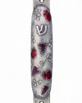 Pewter mezuzah featuring vibrant pomegranates design, crafted by Israeli artist Emanuel, with detailed Hebrew inscriptions and decorative motifs.