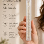 Person presenting the clear acrylic Shema mezuzah showing its transparency.