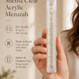 Person presenting the clear acrylic Shema mezuzah showing its transparency.