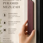 Person naturally holding the exact source mezuzah at realistic scale, with editorial text space, highlighting its shape, color, and material in a premium layout.