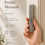 Person holding an exact Jerusalem pewter mezuzah case at realistic size, highlighting traditional design and material.