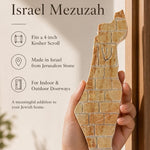 Person holding the Eretz Yisrael cream Jerusalem stone mezuzah, showing its width and gold detail.