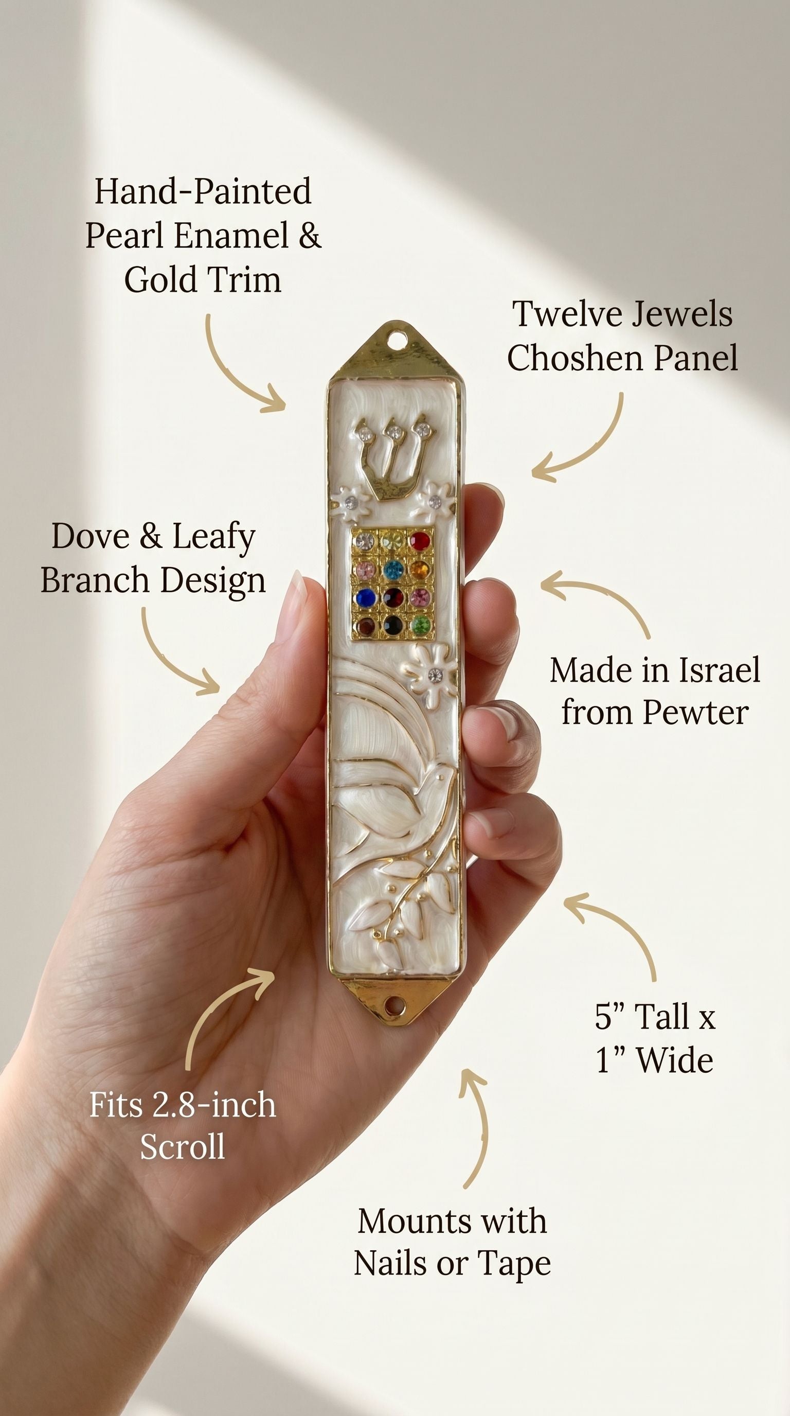 Hand supporting an elegant Pearl enamel mezuzah case with gold trim and dove motif, showcasing its peaceful design and Hebrew details.