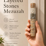 Person holding a genuine Jerusalem stone Mezuzah, showing its natural texture and dimensions in a lifestyle setting.