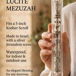 Individual presenting the Clear Jerusalem Silver Plaque Lucite Mezuzah with detailed Jerusalem depiction and Hebrew Shin at true-to-scale.
