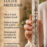 Individual presenting the Clear Jerusalem Silver Plaque Lucite Mezuzah with detailed Jerusalem depiction and Hebrew Shin at true-to-scale.