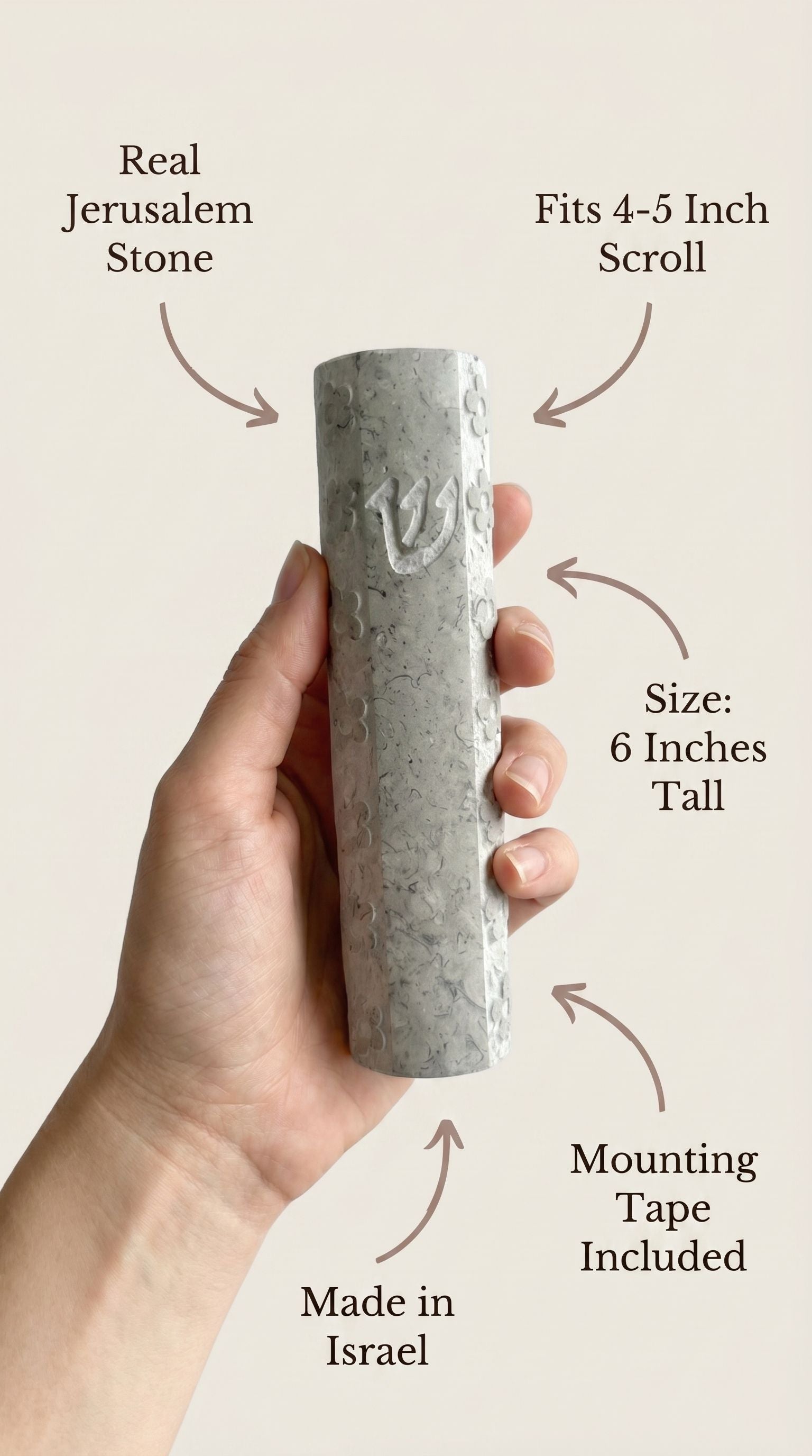 Person holding Jerusalem stone mezuzah in hand, emphasizing material and craftsmanship.