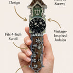 Person gently holding the Timeless Clock mezuzah, highlighting its material, design, and handcrafted details.