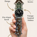 Person gently holding the Timeless Clock mezuzah, highlighting its material, design, and handcrafted details.