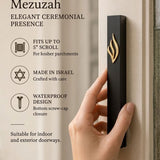 Person holding the Eternal Flame black aluminum mezuzah in natural light, showcasing its design and scale.