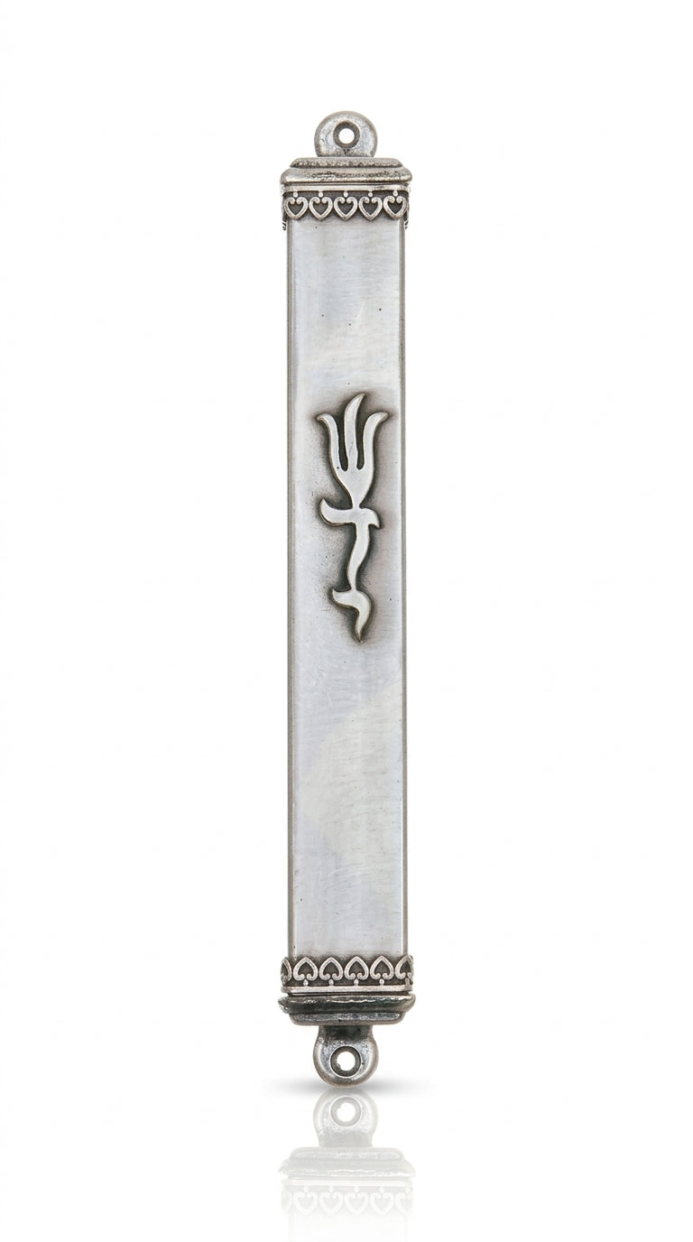 Elegant pewter mezuzah with hearts on each end, shown in a bright studio setting with clean white background and subtle reflection.
