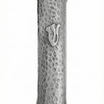 High-resolution image of a simple pewter Mezuzah with the letter 'Shin', featuring intricate details and textured finish, on a white studio background with soft reflection.