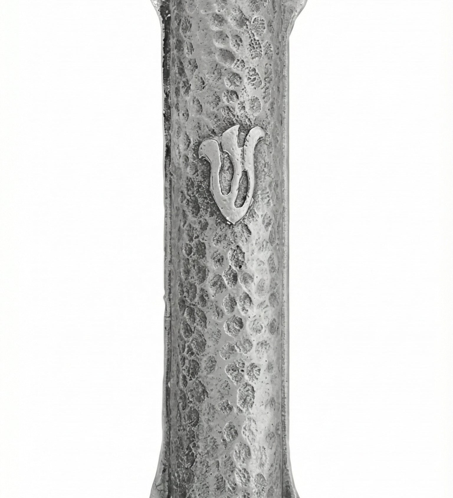High-resolution image of a simple pewter Mezuzah with the letter 'Shin', featuring intricate details and textured finish, on a white studio background with soft reflection.