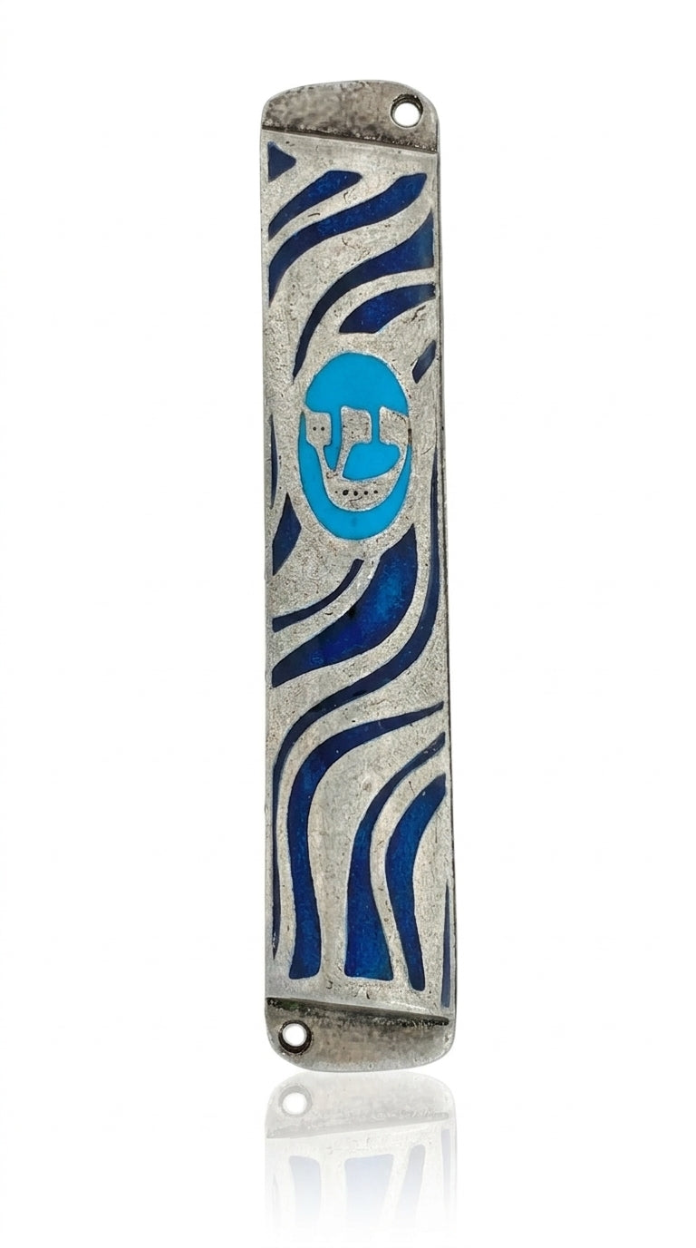Petite pewter finish mezuzah case with Hebrew letters, decorative motifs, and smooth curves, displayed on a white studio surface with a subtle reflection.