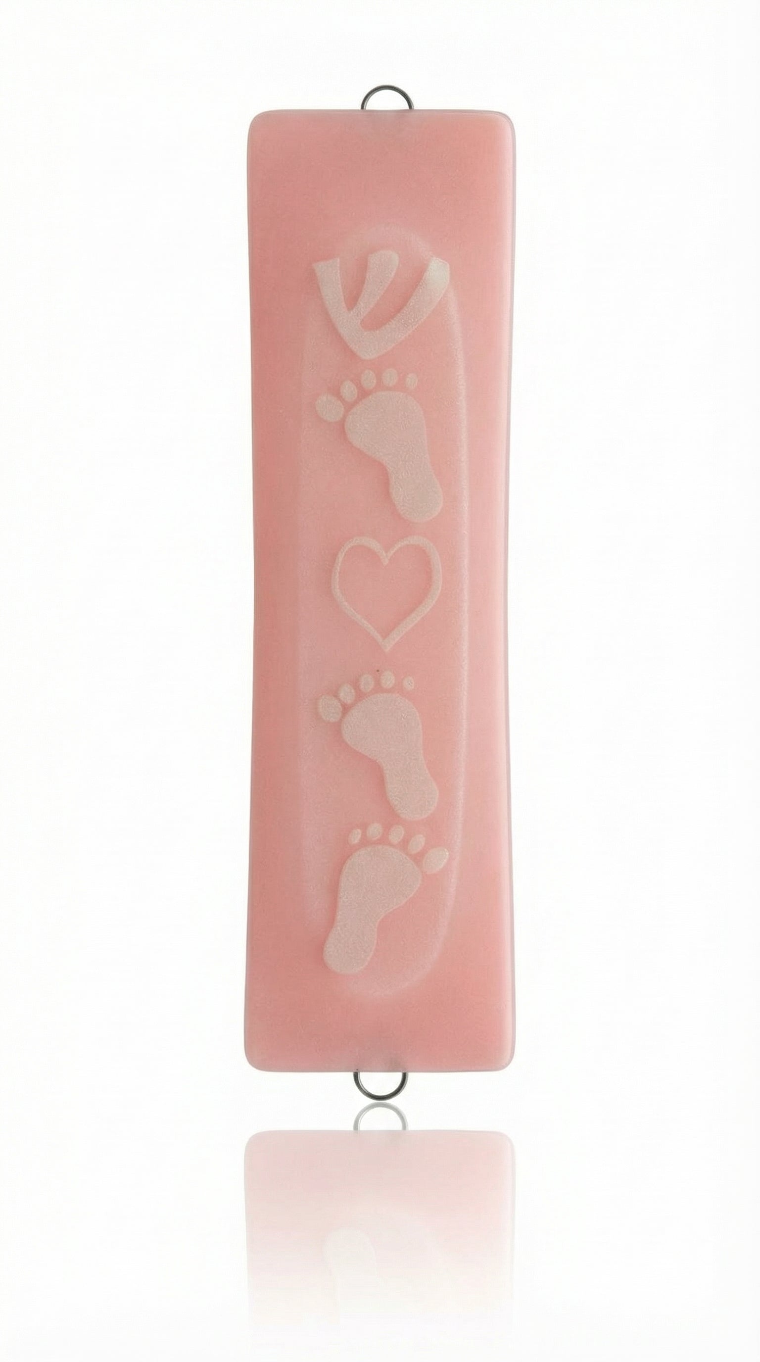 Pink glass mezuzah decorated with adorable baby feet design, displayed on a white background with soft reflection for an elegant look.