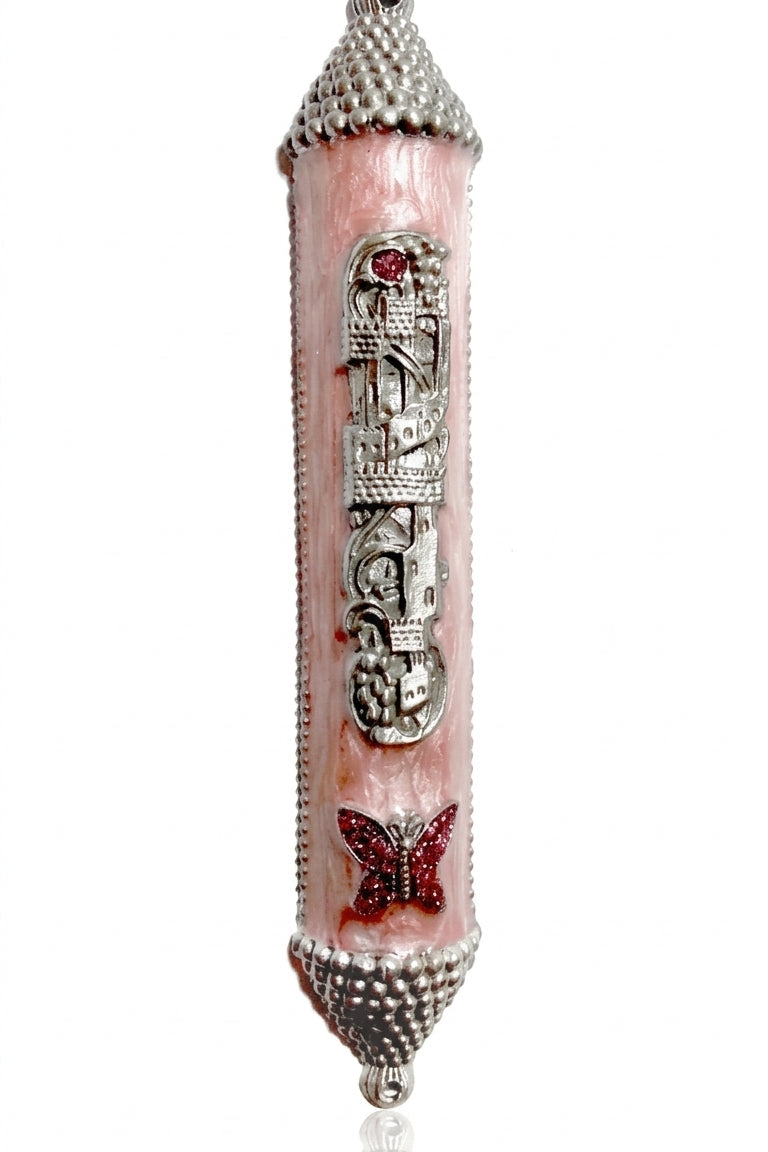 Pink castle-shaped mezuzah with sparkling pink butterfly charm, Hebrew lettering, and enamel paint, designed for princess-themed home decor.