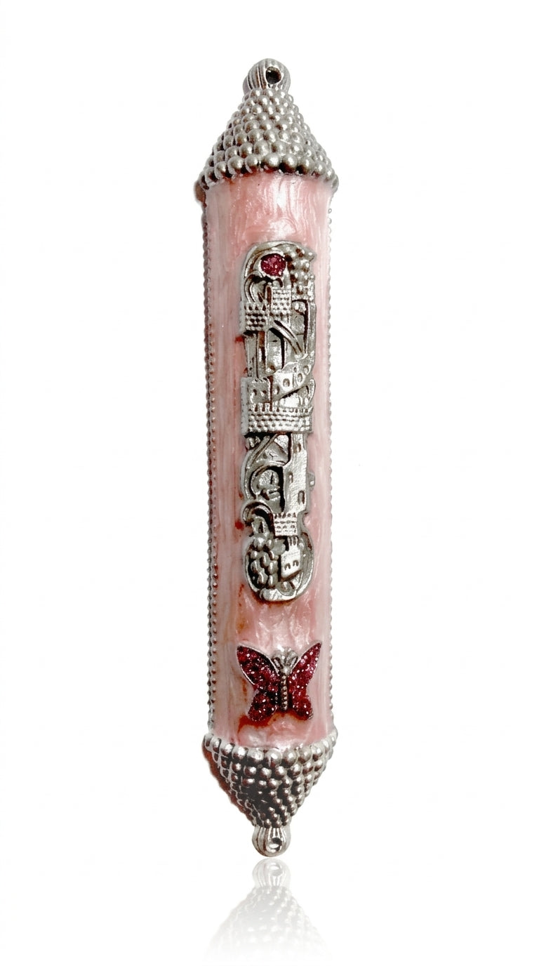 Pink castle-shaped mezuzah with sparkling pink butterfly charm, Hebrew lettering, and enamel paint, designed for princess-themed home decor.
