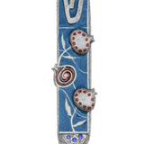Pewter Mezuzah with artistic pomegranate design, hand-painted with enamel, displayed on a white studio background with subtle reflection.