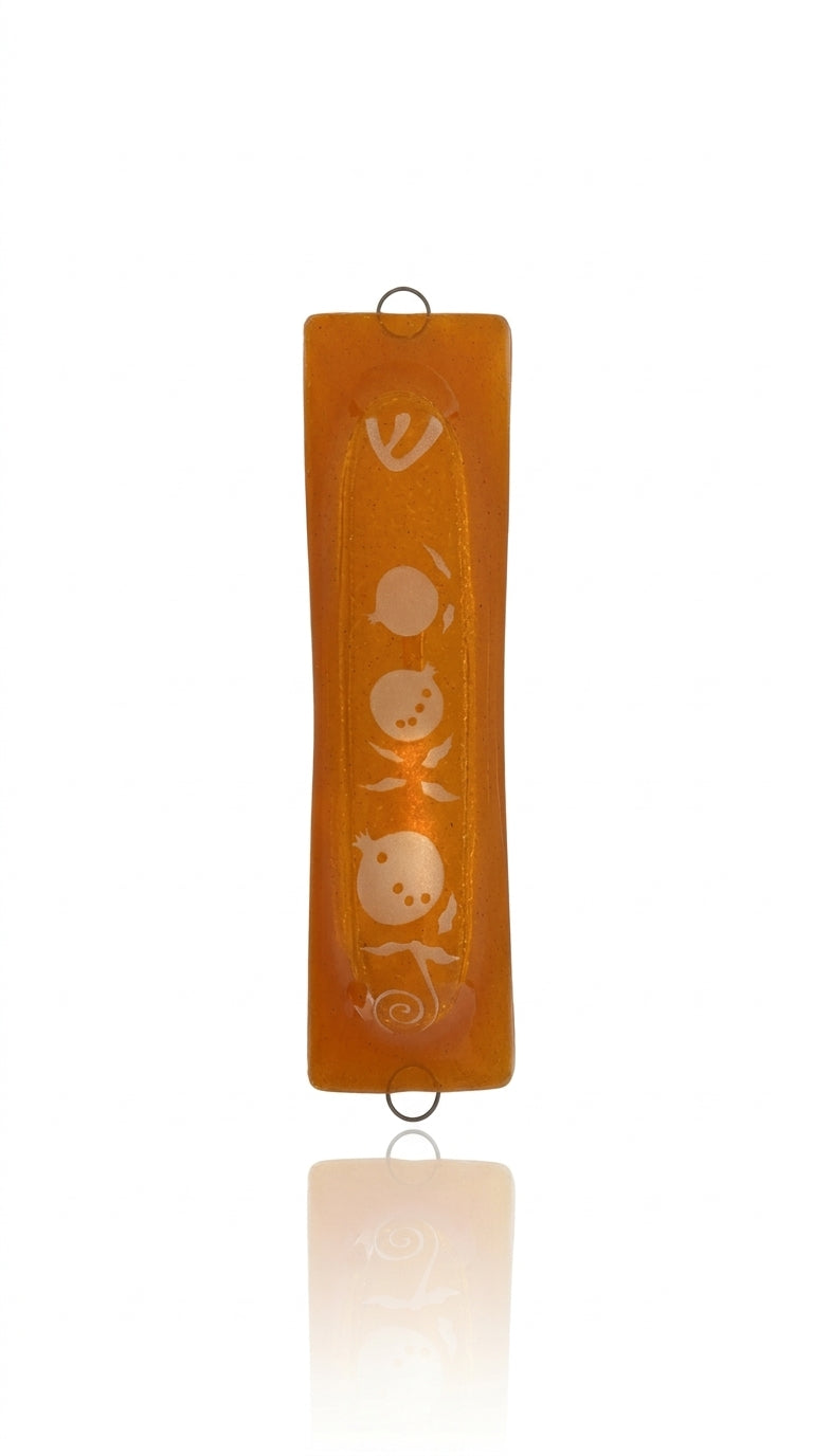 Elegant Pomegranate Glass Mezuzah made in Israel, detailed with Hebrew engravings and decorative motifs, placed on a clean white background with soft reflection.