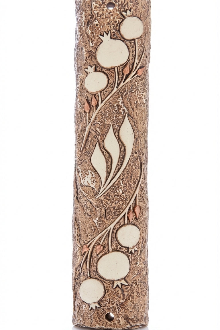 Detailed pomegranate motif Mezuzah designed by Israeli artist, symbolizing Jewish tradition and filled with Mitzvot, on a bright white background with soft reflection.