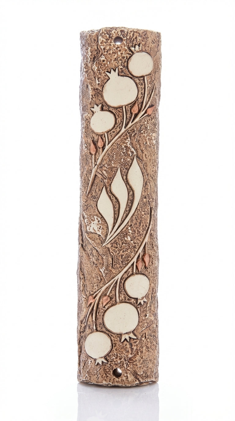 Detailed pomegranate motif Mezuzah designed by Israeli artist, symbolizing Jewish tradition and filled with Mitzvot, on a bright white background with soft reflection.