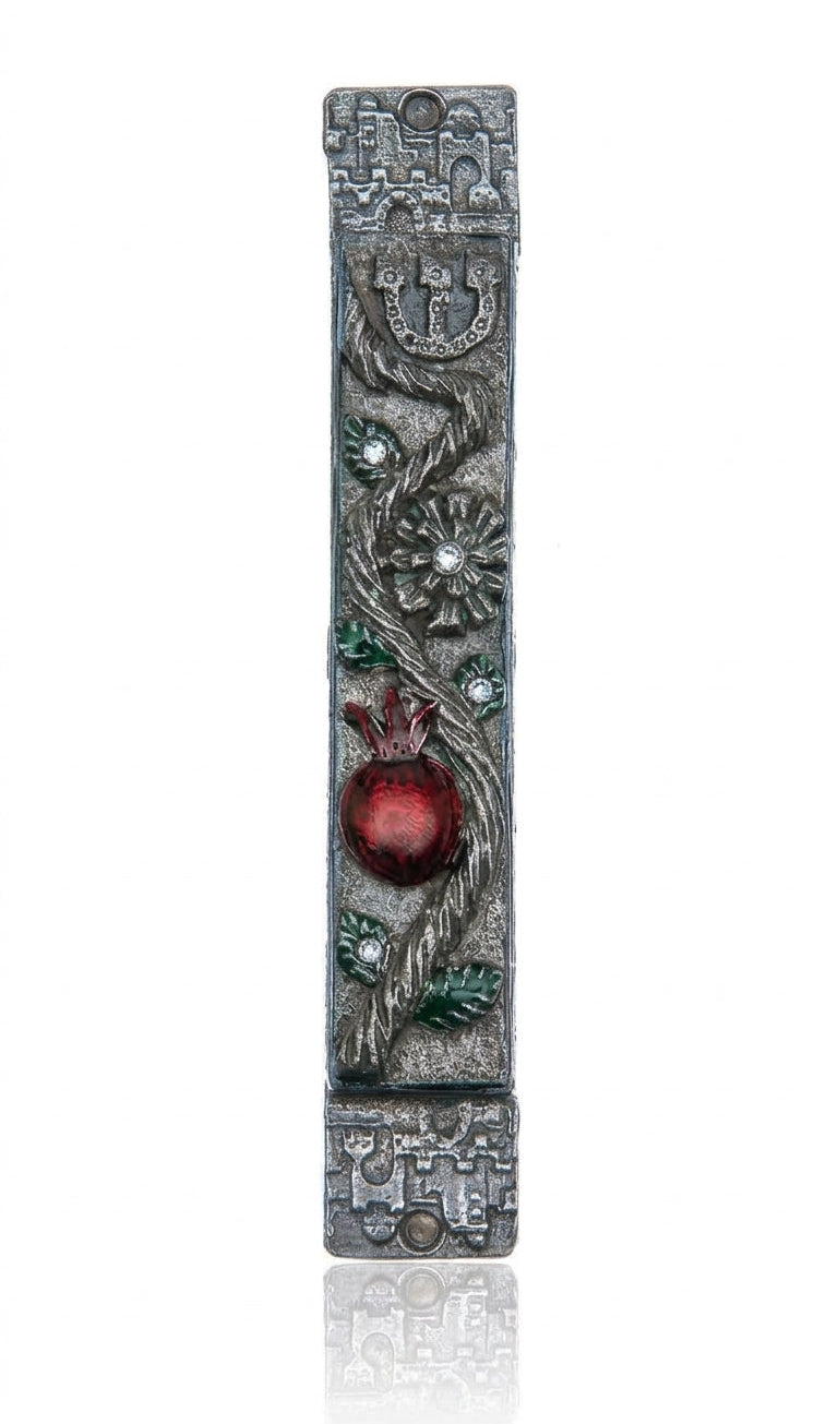 Detailed pomegranate mezuzah made of pewter with hand-painted enamel, featuring Hebrew inscriptions and decorative motifs, suitable for doorposts.