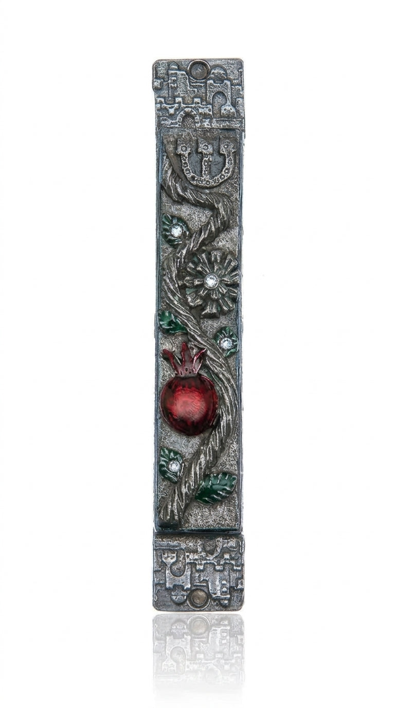 Detailed pomegranate mezuzah made of pewter with hand-painted enamel, featuring Hebrew inscriptions and decorative motifs, suitable for doorposts.