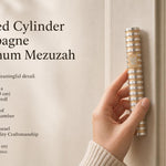 Person holding the exact Grooved Cylinder Champagne Aluminum Mezuzah in a natural pose, showcasing its sculptural profile and design details.