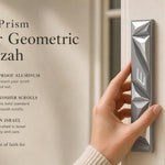 Person holding the Cyber Prism Silver Geometric Mezuzah with editorial text and generous negative space in a styled frame.
