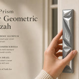 Person holding the Cyber Prism Silver Geometric Mezuzah with editorial text and generous negative space in a styled frame.