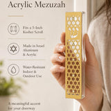 Elegant shot of a person presenting the gold acrylic mezuzah for showcase, emphasizing its design and craftsmanship.