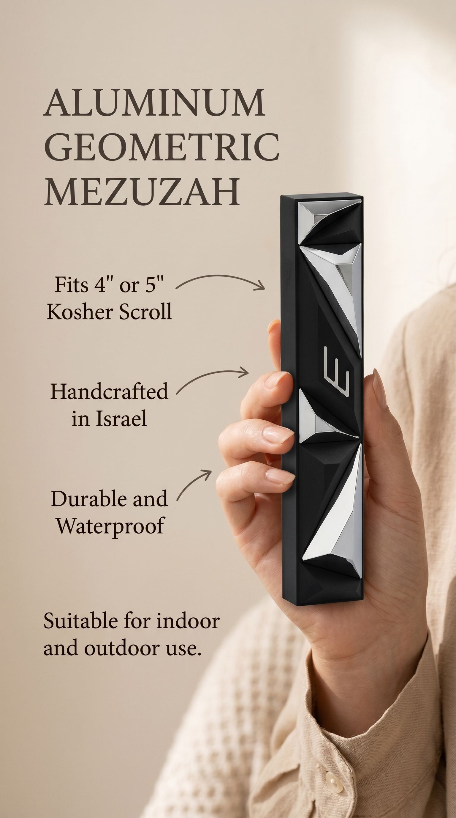 Hand-held black aluminum mezuzah with Hebrew scroll, showcasing detailed contours and traditional design.
