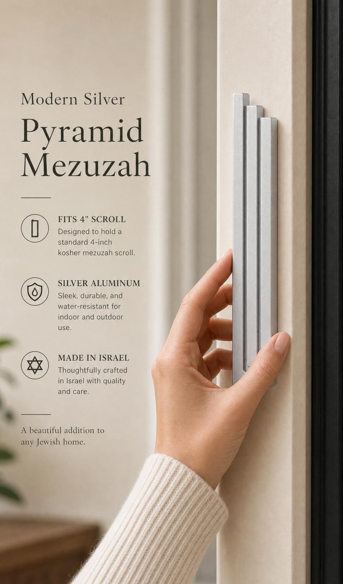 Person holding the exact modern silver pyramid mezuzah against a neutral background, demonstrating its size and design.