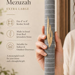 Close-up of the gray Jerusalem stone mezuzah in natural light showing tonal variation in the stone.