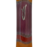Elegant purple glass mezuzah measuring 4.5 inches with Hebrew inscriptions and decorative motifs, displayed on a white studio surface with light reflection.