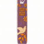 Decorative mezuzah case with floral and bird design on a white background
