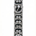 High-resolution image of a pewter Ram Mezuzah with curved ram horn shapes, accented with clear sequins, set against a bright white studio background with a subtle reflection.