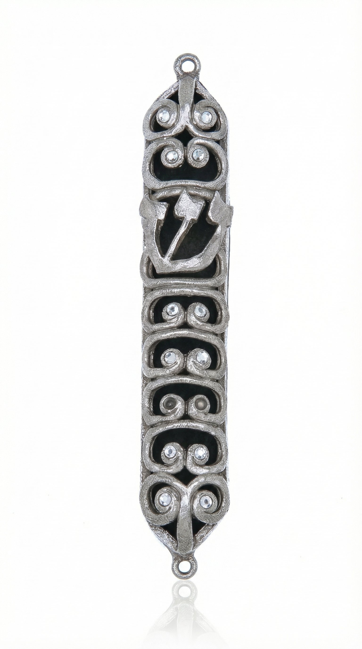 High-resolution image of a pewter Ram Mezuzah with curved ram horn shapes, accented with clear sequins, set against a bright white studio background with a subtle reflection.