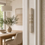 Birkat HaBayit stone mezuzah mounted on a doorway doorpost in natural indoor light.