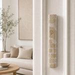 Home entrance with the Kotel cream Jerusalem stone mezuzah angled on the upper third of the right doorpost.