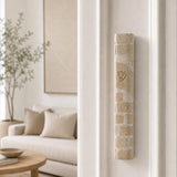 Home entrance with the Kotel cream Jerusalem stone mezuzah angled on the upper third of the right doorpost.