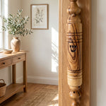 Lifestyle room scene with olive wood mezuzah mounted on door, highlighting natural material and home decor.
