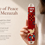 Hand-held red Dove of Peace mezuzah with blue and white accents, showcasing its vibrant ceramic finish and Judaica motifs for doorway decoration.