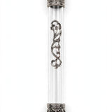 Regal Crown Pewter and Clear Acrylic Mezuzah shown from the front as a mezuzah cover featuring a transparent acrylic chamber framed by silver-toned pewter crown ends, dark recessed decoration and curling silver scrollwork down the front, presenting a detailed Judaica design for a Jewish home doorway