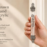 Regal Crown Pewter and Clear Acrylic Mezuzah mezuzah cover held upright in one hand, showing a transparent acrylic chamber framed by silver-toned pewter crown ends, dark recessed decoration and curling silver scrollwork down the front beside the product name and illustrated design features in a wide social-sharing graphic for decorative Jewish home Judaica