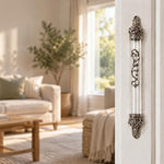 Regal Crown Pewter and Clear Acrylic Mezuzah mounted vertically on a pale home doorpost, with a transparent acrylic chamber framed by silver-toned pewter crown ends, dark recessed decoration and curling silver scrollwork down the front creating a distinctive mezuzah cover that brings its Jewish design and decorative detail into the doorway